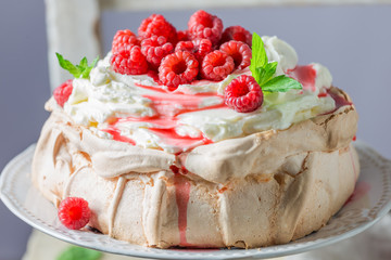 Homemade and rustic Pavlova cake made of mascarpone and berries