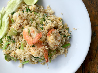 Delicious Shrimp fried rice in white dish on wooden table. Thai food.