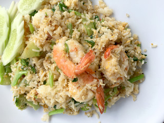 Delicious Shrimp fried rice in white dish on wooden table. Thai food.