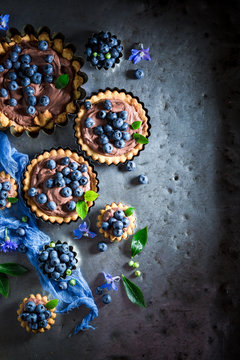 Homemade and rustic tarts made of brown cream and berries