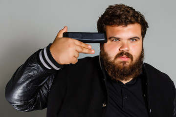 portrait of a young angry man using a remote control indoor