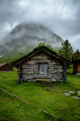Scenic view of old wooden house with grass on the roof, traditional norway house.