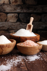 sea salt in bowl. Crystals of salt on table and himalayan salt