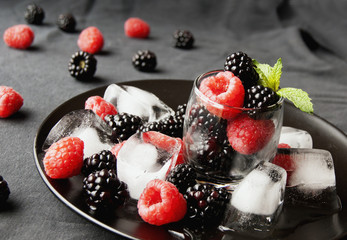 black berries and raspberries in a glass cup