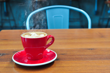 Coffee cup in coffee shop,red Cup of coffee on a wooden table,cup of coffee on table in cafe,cup of cappuccino