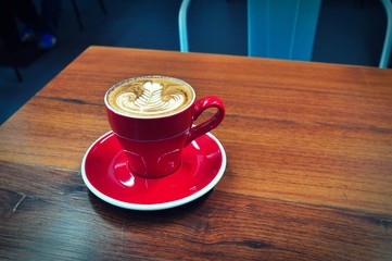 Coffee cup in coffee shop,red Cup of coffee on a wooden table,cup of coffee on table in cafe,cup of cappuccino