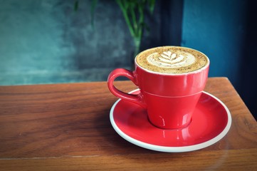 red  cup of hot coffee on wooden table in coffee shop,red cup