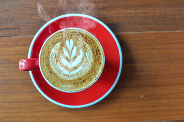 red  cup of hot coffee on wooden table in coffee shop,red cup