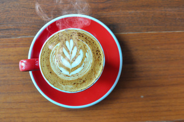 red  cup of hot coffee on wooden table in coffee shop,red cup