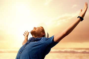 Composite image of happy man raising his arms up  - Powered by Adobe