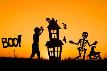 Happy little boy playing outdoors at the sunset time.