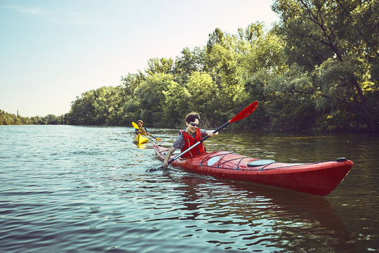 A canoe trip along the river along the forest in summer.