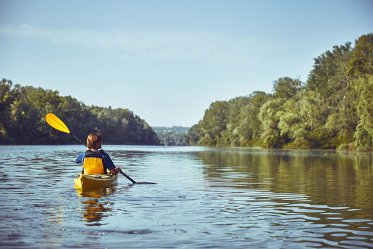 A canoe trip along the river along the forest in summer.