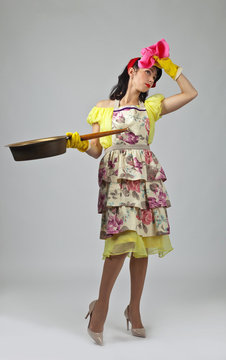  Housewife in rubber glove  with  big pan .