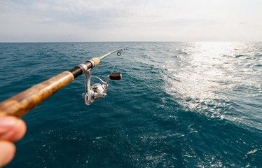 Fisherman fishing rod on the sunset closeup