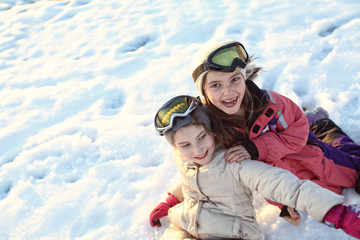 Fototapeta na wymiar Young happy girls have fun on a winter sunny day
