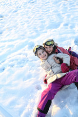 Fototapeta na wymiar Happy and cheerful girls spend the air on a cold winter day