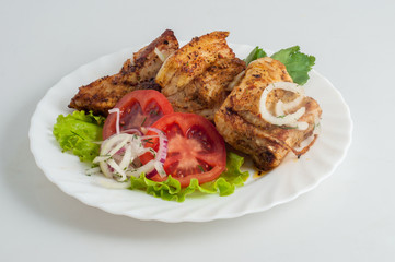 Beef pork barbecue kebab on skewer on a white plate