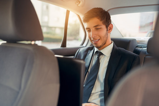 Young businessman working inside the car