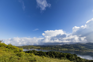 Brilliant morning blue sky and clouds over Loch Ailort, Scotland.