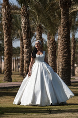 Fototapeta na wymiar Bride on sunny day on natural background