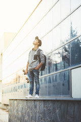 Young man with backpack and skateboard