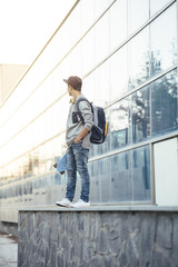 Young man with backpack and skateboard