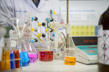Asian scientists are experimenting with measuring pH in a chemical laboratory.