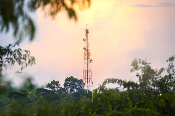 The telephone tower was in the middle of the forest when the sun was setting and the sun was very beautiful. - Powered by Adobe