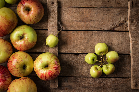 Green and red apples on rustic  table. Flat lay