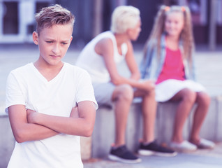 Upset boy after quarrel with playmates