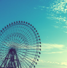 Close up of Ferris wheel on blue sky with cloud background in japan,copy space