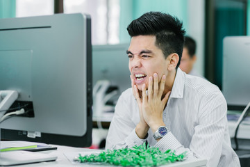 Portrait of handsome young businessman having headache at office. Asia people businessman.