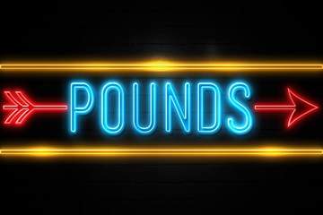 Pounds  - fluorescent Neon Sign on brickwall Front view