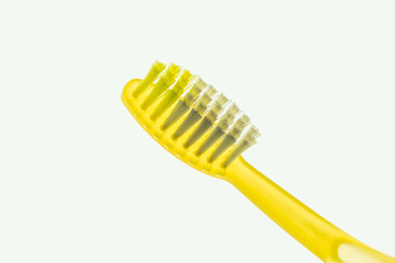 Backlit yellow toothbrush isolated on a white background