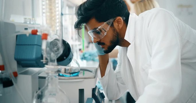 Male student of chemistry working in laboratory