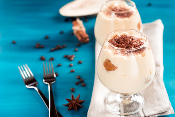 luxurious dessert Tiramisu in a glass on a blue background