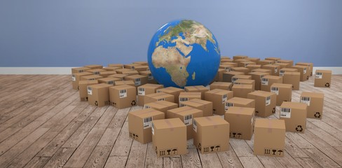 Composite image of 3d image of globe amidst cardboard boxes