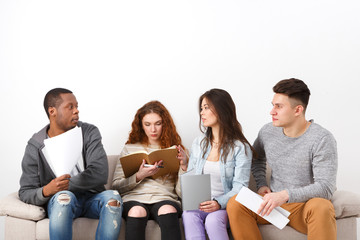 Diverse young students preparing for exam at home