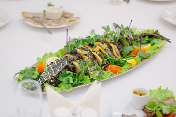 Big fish on table during catering event. Catering buffet.