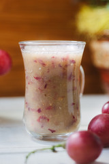 Grape smoothie over the white table.