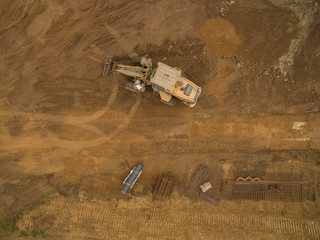 aerial view top view of a wheel loader bulldozer on construction site