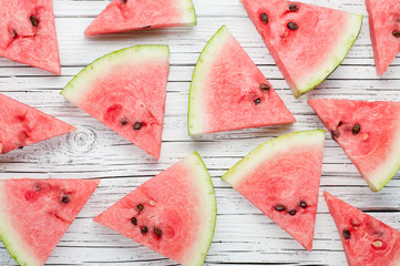 watermelon slices on white wooden background top view