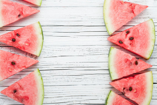 watermelon slices on white wooden background top view