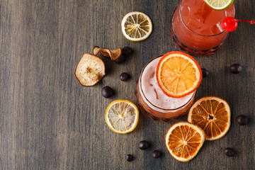 Obraz na płótnie Canvas Blood orange margarita cocktail at wooden background