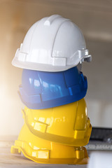 Stack of Safety helmets,white,Blue and yellow helmets in construction site.