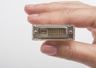Female hand holding DVI connection cable isolated on white background