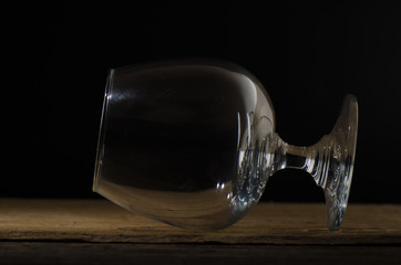 Glass of brandy and a couple of chocolate truffles with cinnamon sticks tied with jute rope on an...