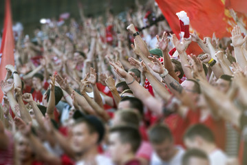 Football fans clapping on the podium of the stadium