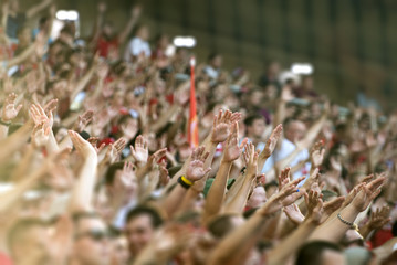 Fototapeta Football fans clapping on the podium of the stadium obraz